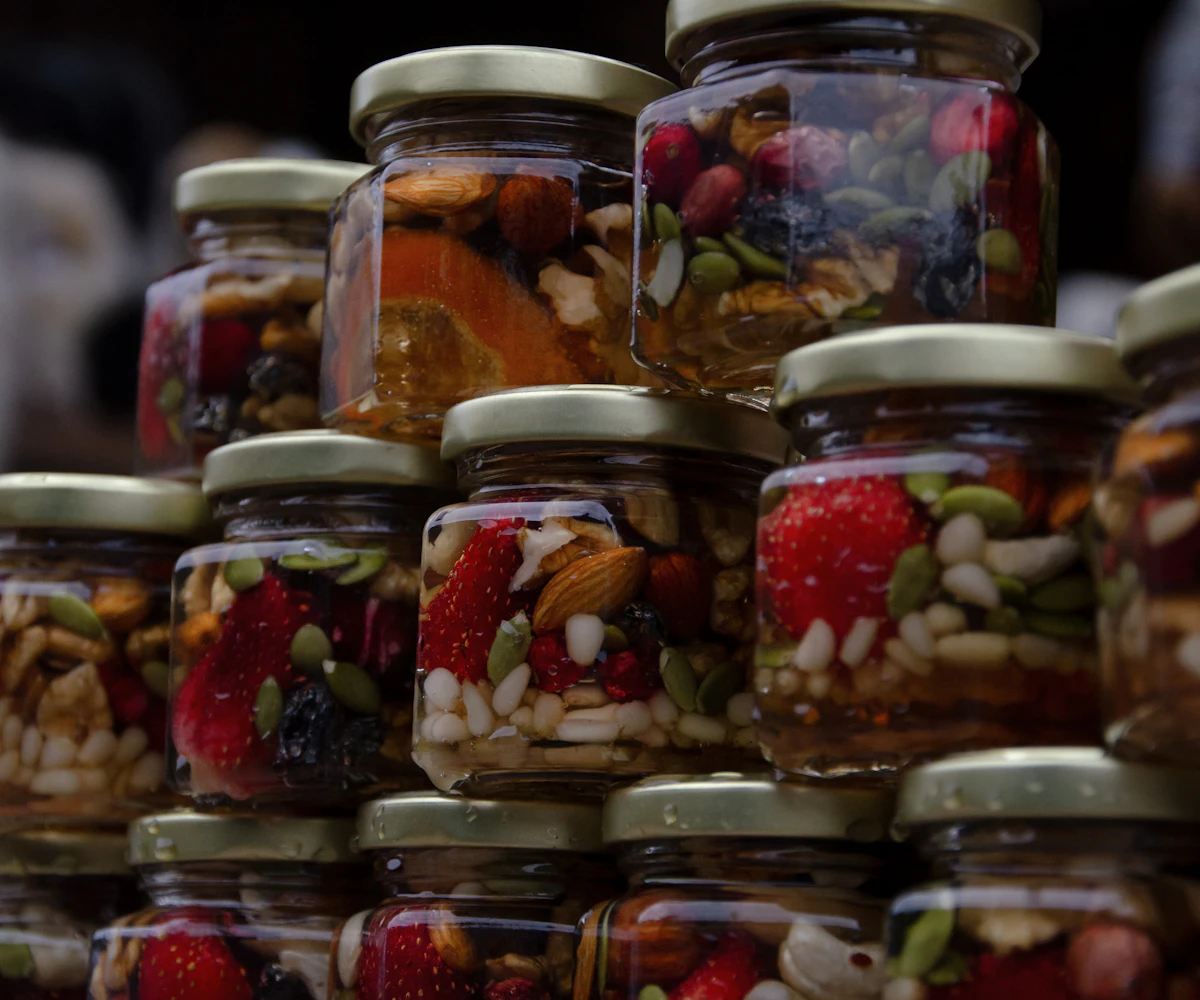 Glass jars filled with dried fruits, nuts and seeds